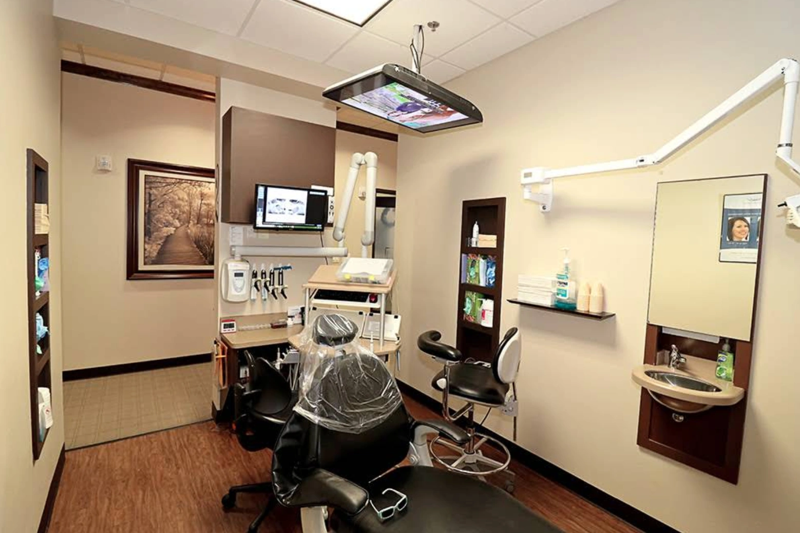 Todd Dental Co. treatment room with dental chair and monitors